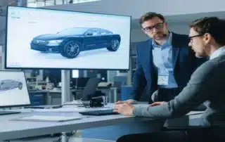 Engineers examining a car design 3D model in an office studio